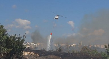 Avcılar'da otluk alanda çıkan yangın helikopter yardımıyla söndürüldü